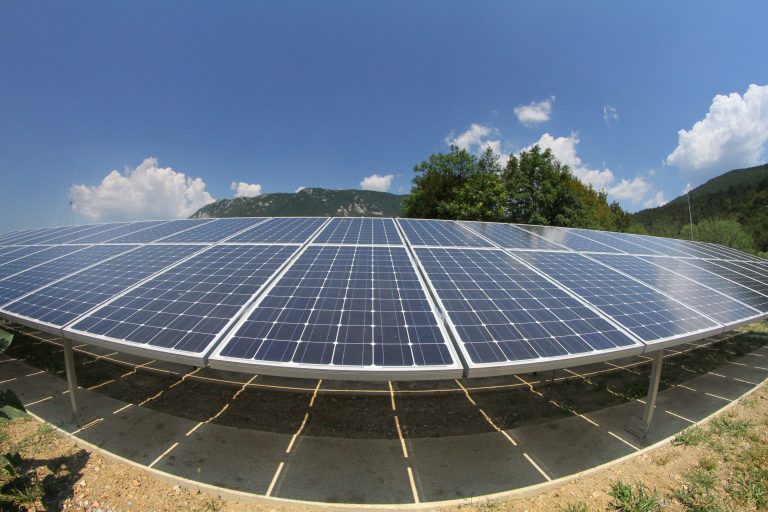 The bright blue solar panels under a sunny sky